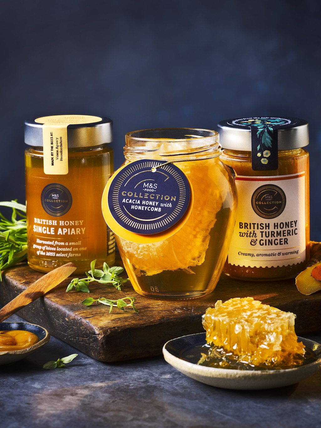 Three jars on honey on wooden board