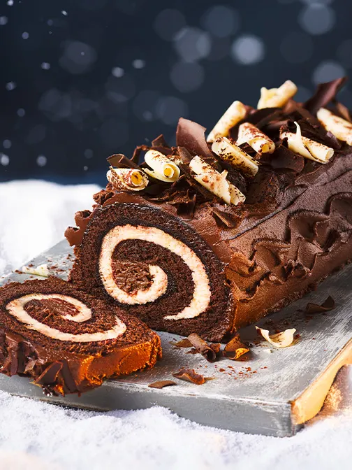 Chocolate yule log with slice cut off