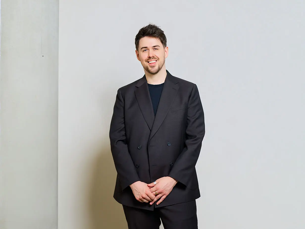 Alex M&S Menswear team wearing a brown suit