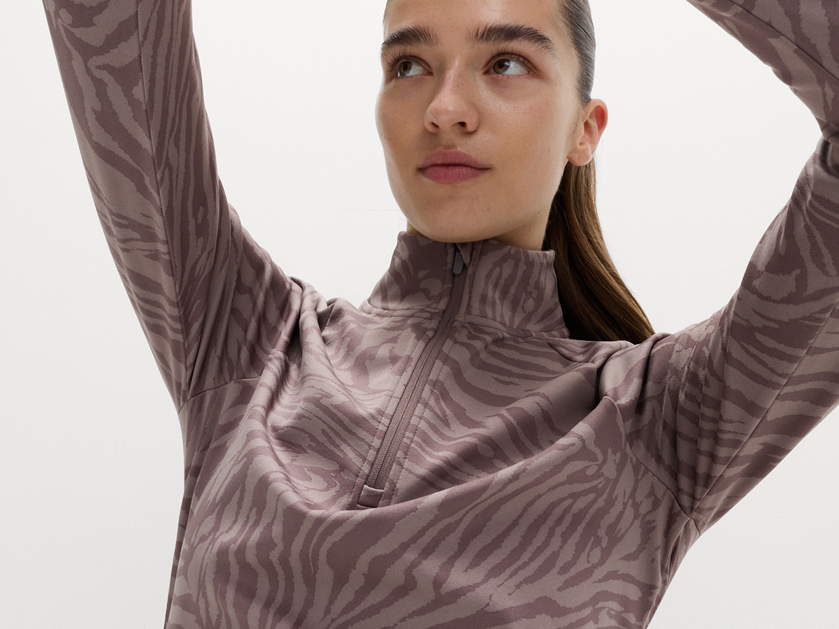 Woman wearing mauve zebra-print sports top