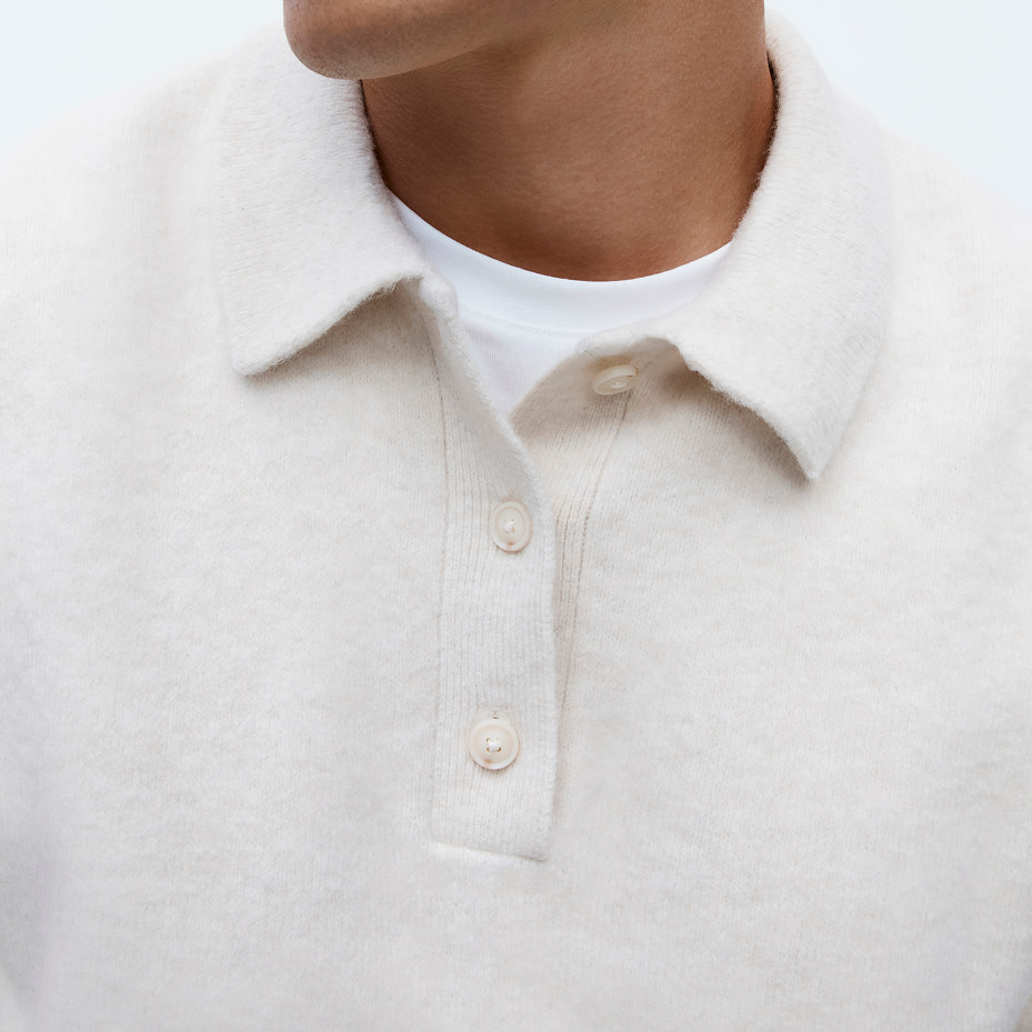 Man wearing white knitted polo top