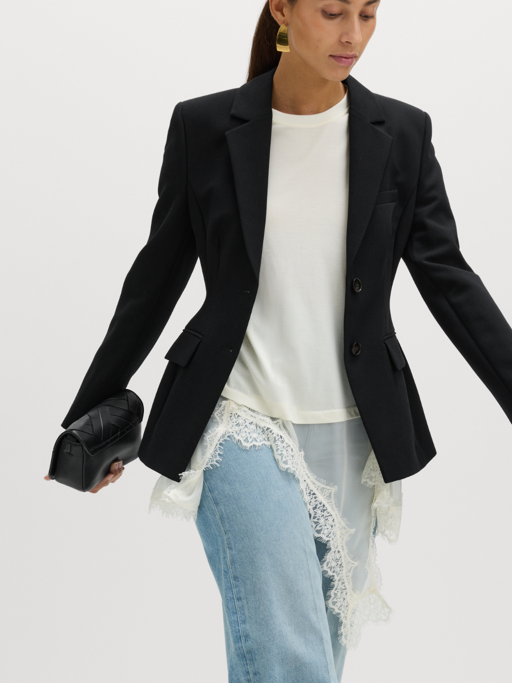 Woman wearing slip dress with jeans and blazer