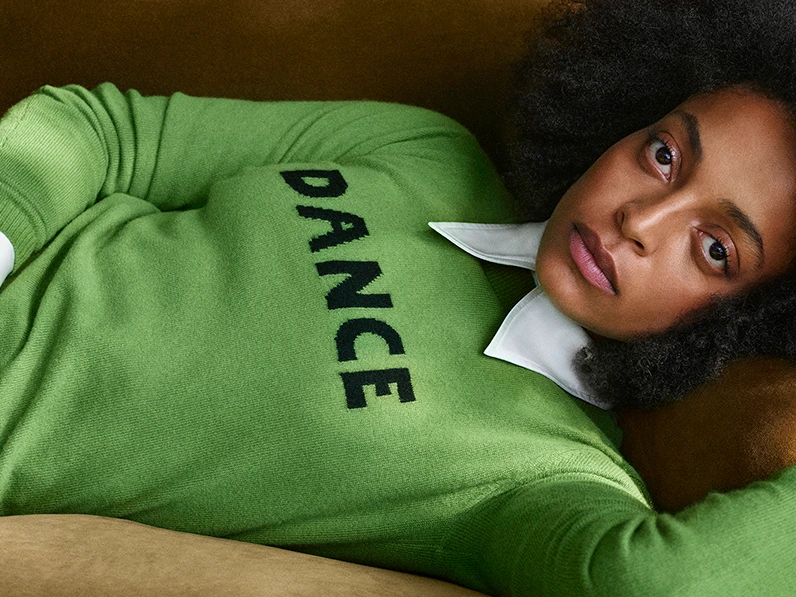 Woman wearing green 'Dance' jumper by M&S x Bella Freud