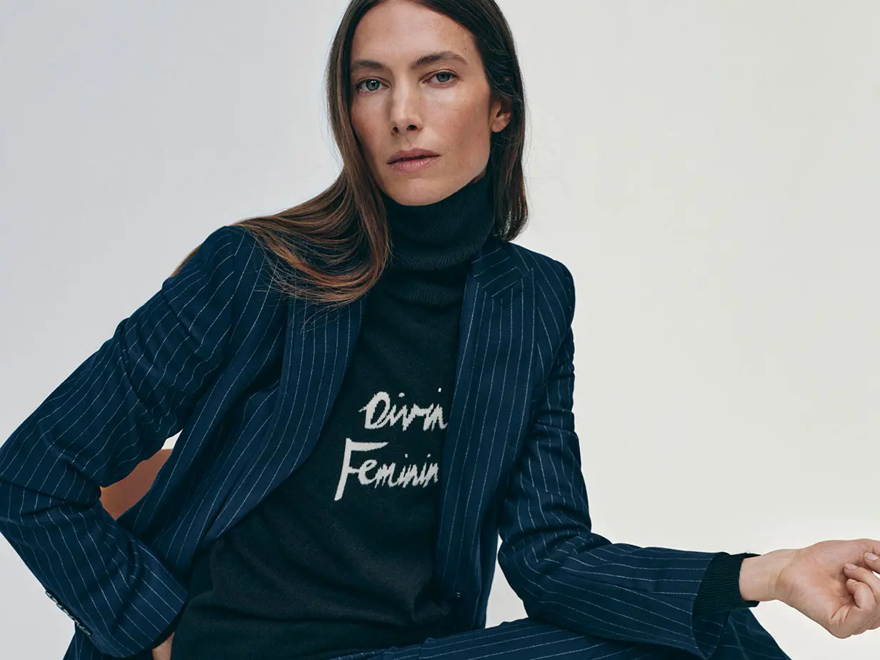 Woman wearing blue blazer and jumper by M&S x Bella Freud