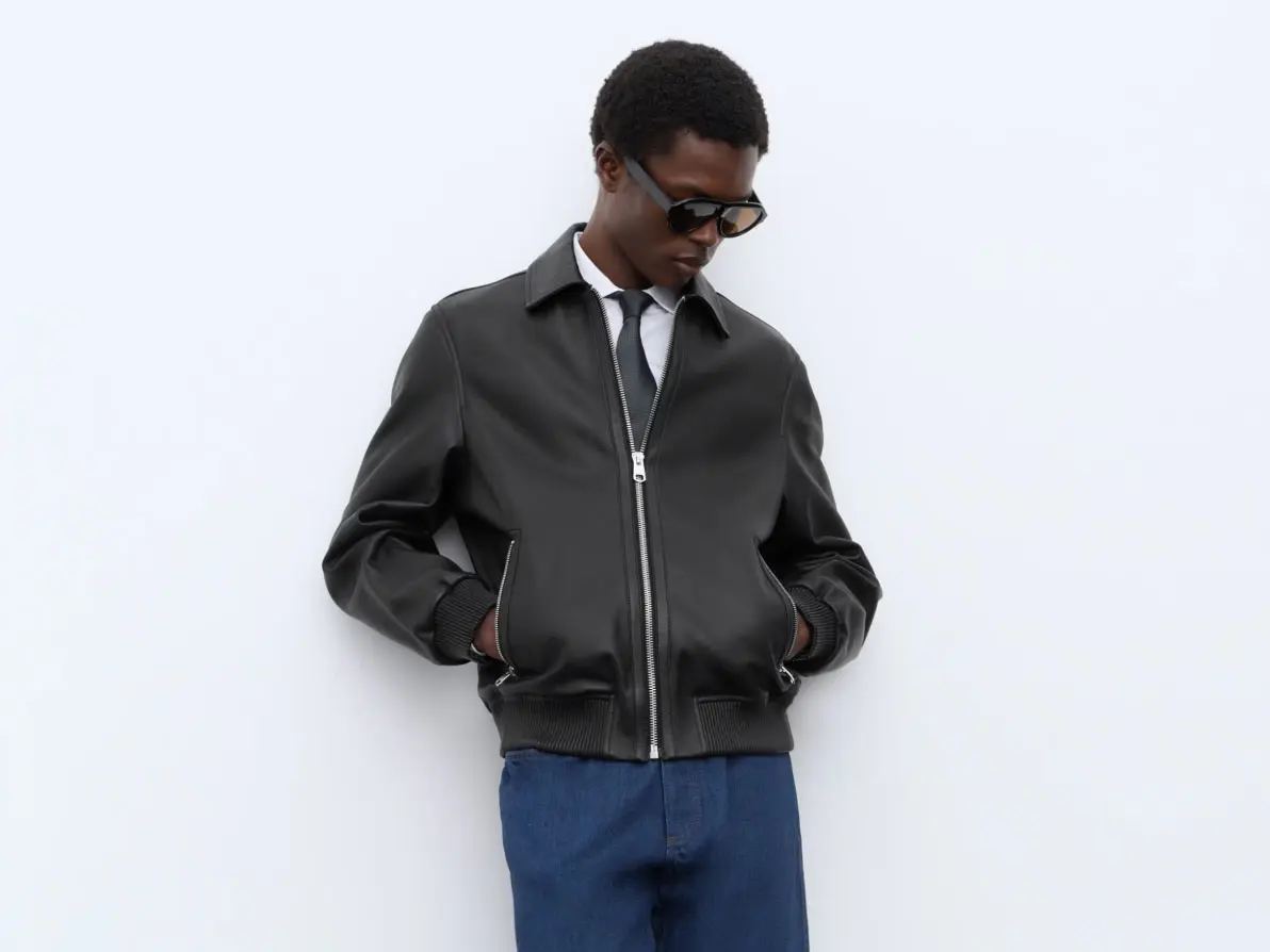 Man wearing black leather jacket with blue jeans