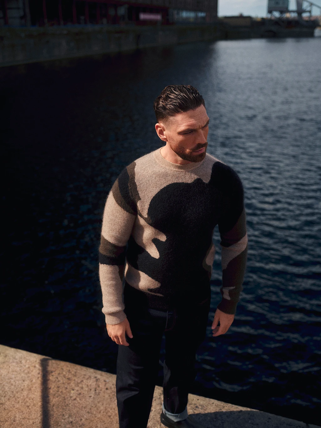 James Nelson Joyce wearing a camouflage jumper by Autograph