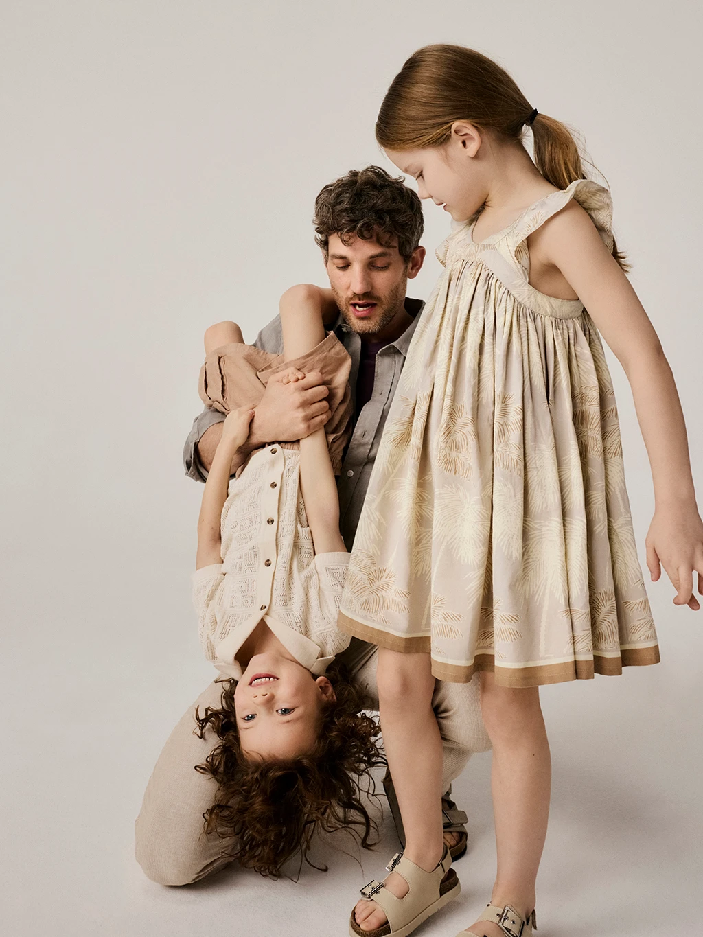 Father, son and daughter wearing co-ordinating outfits