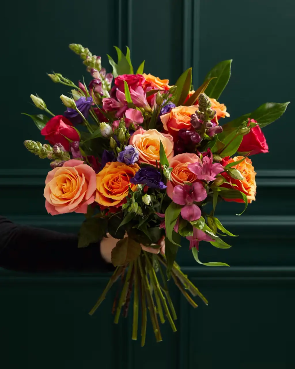 Hand holding bouquet of flowers