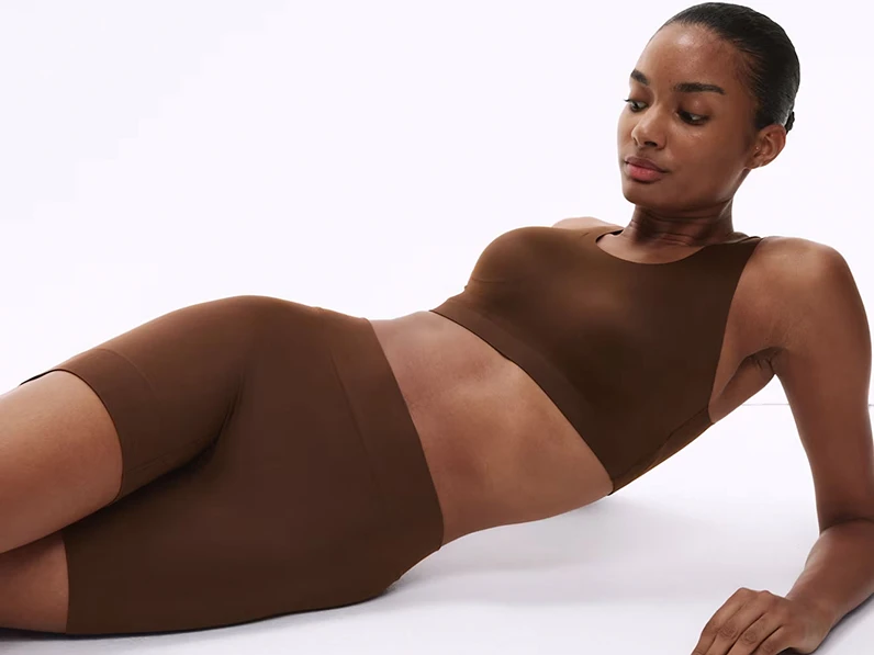 Woman wearing brown crop top and anti-chafing shorts