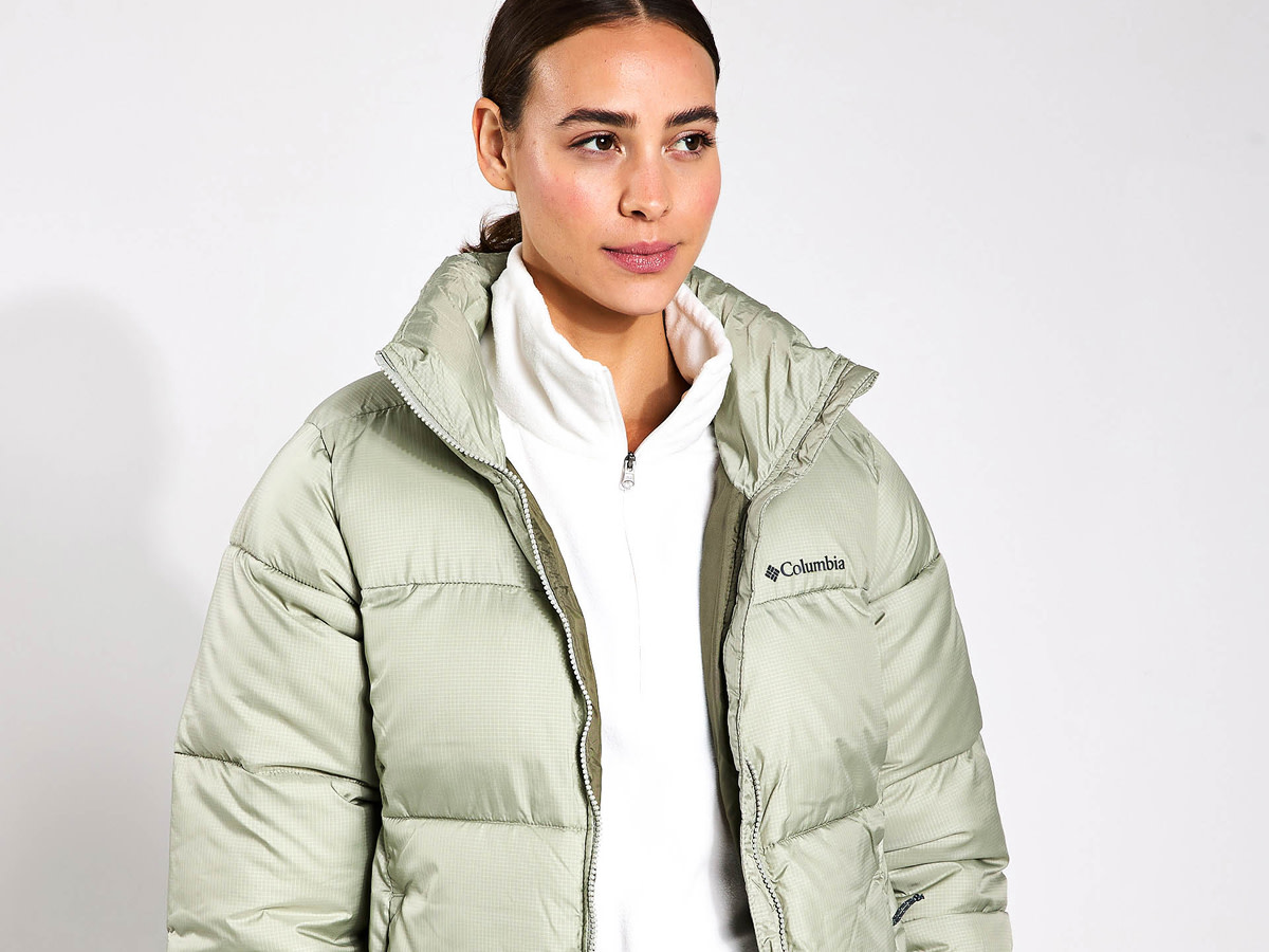 Woman wearing green puffer coat by Napapijri