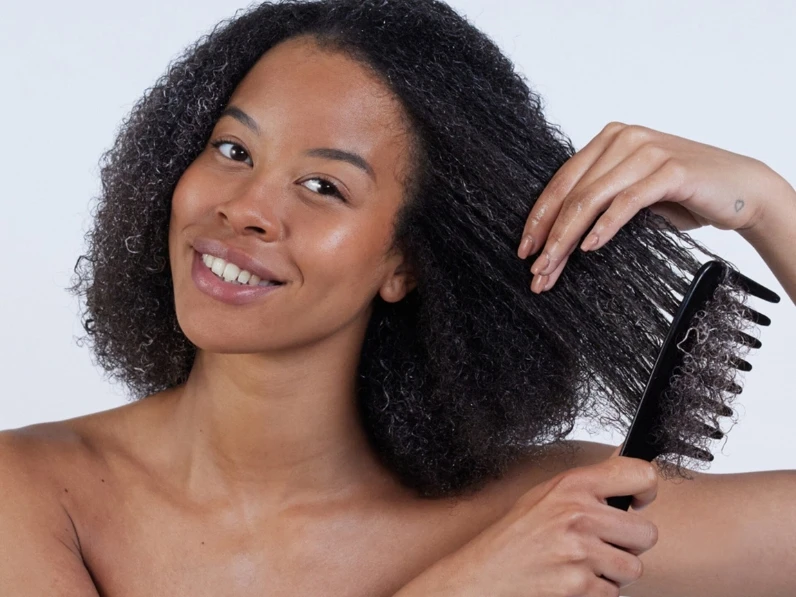 Woman conditioning hair to avoid damaged hair
