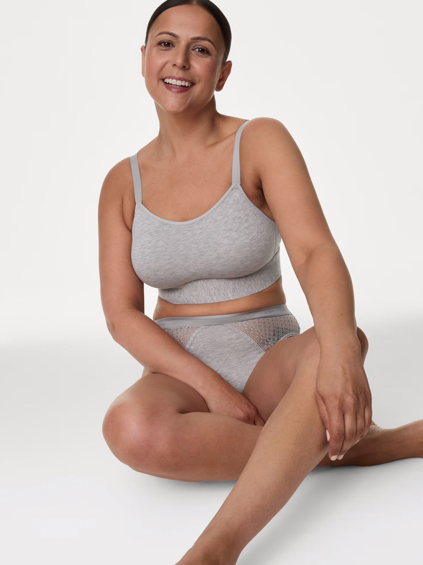 Woman wearing grey post-surgery bra. Shop now