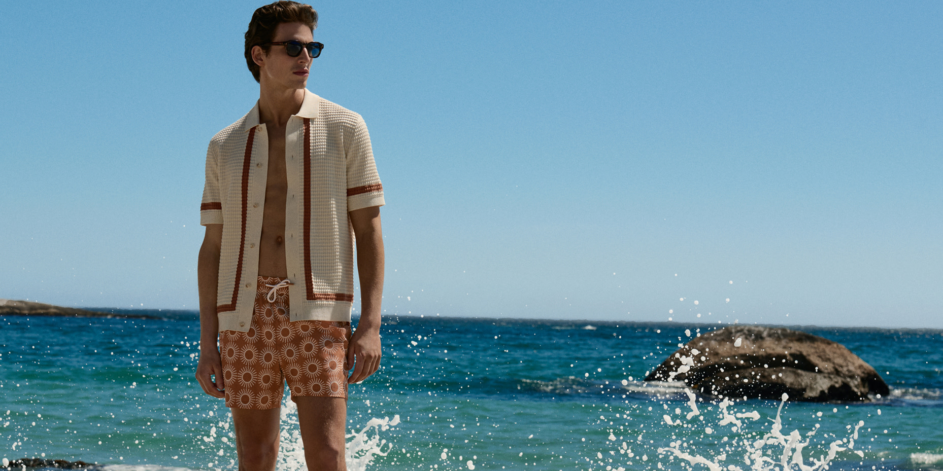 Man wearing shirt and printed shorts