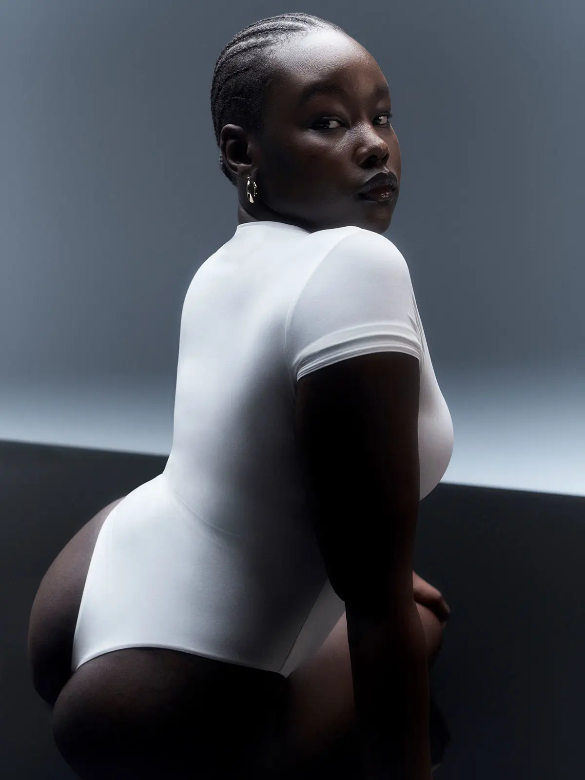 Woman wearing white bodysuit 