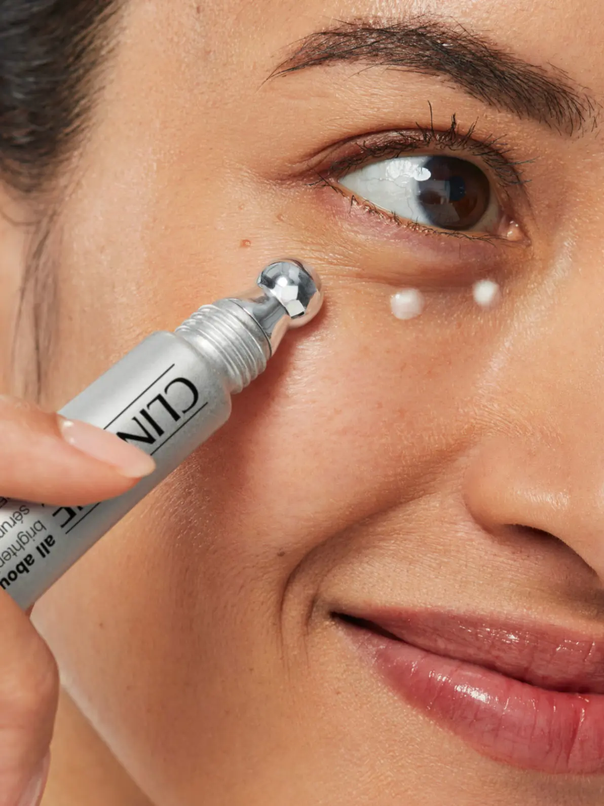 Woman applying eye cream
