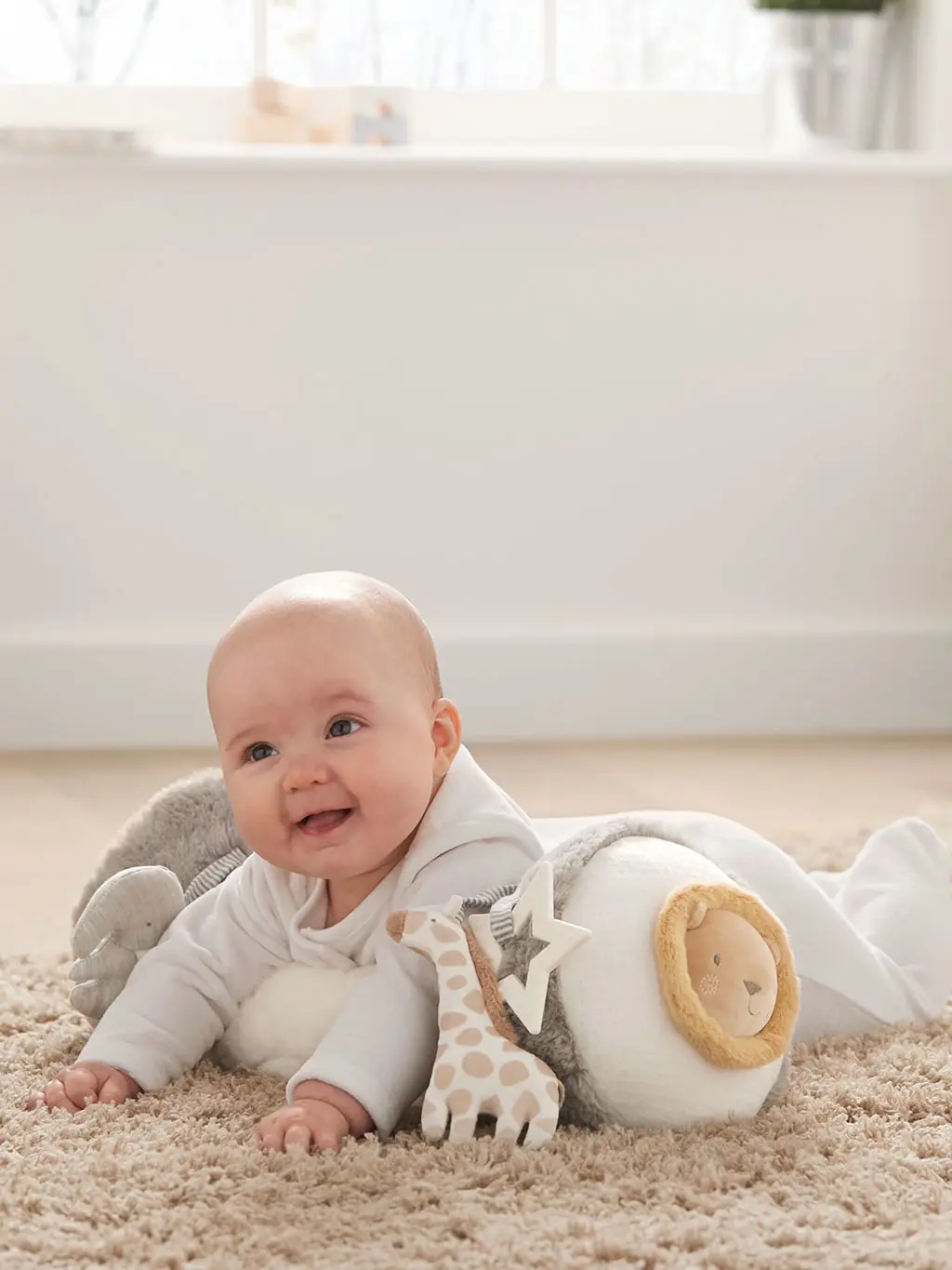 Baby on tummy time roll toy