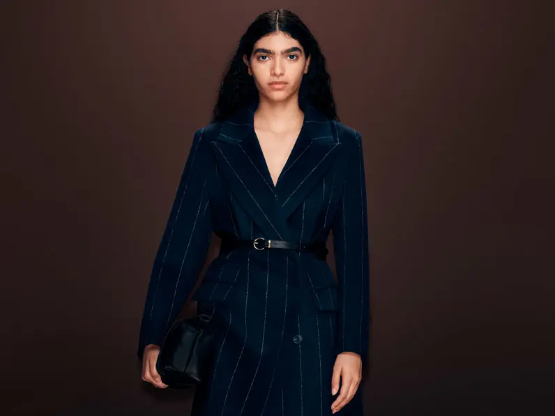 Woman wearing a navy Autograph coat