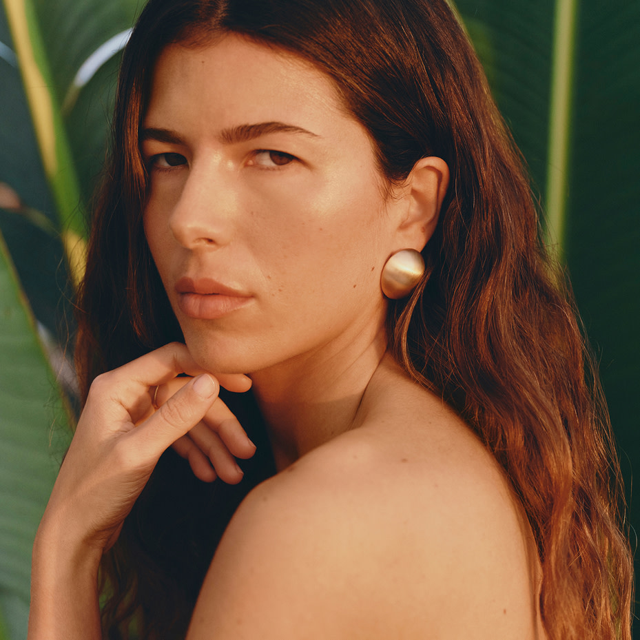 Close up of woman wearing gold earrings