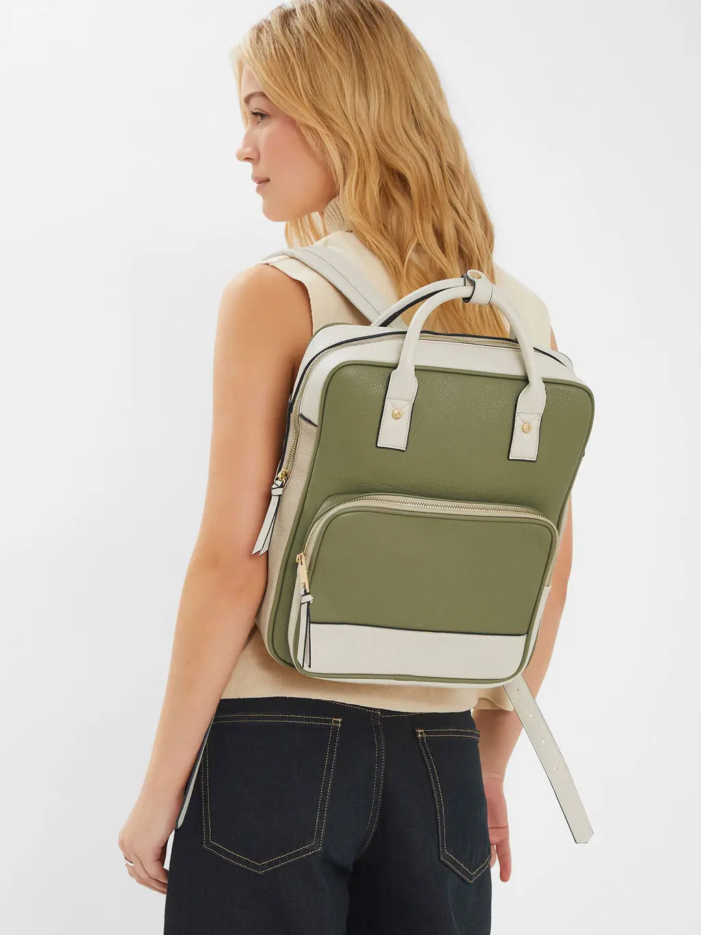 Woman wearing cream and green backpack