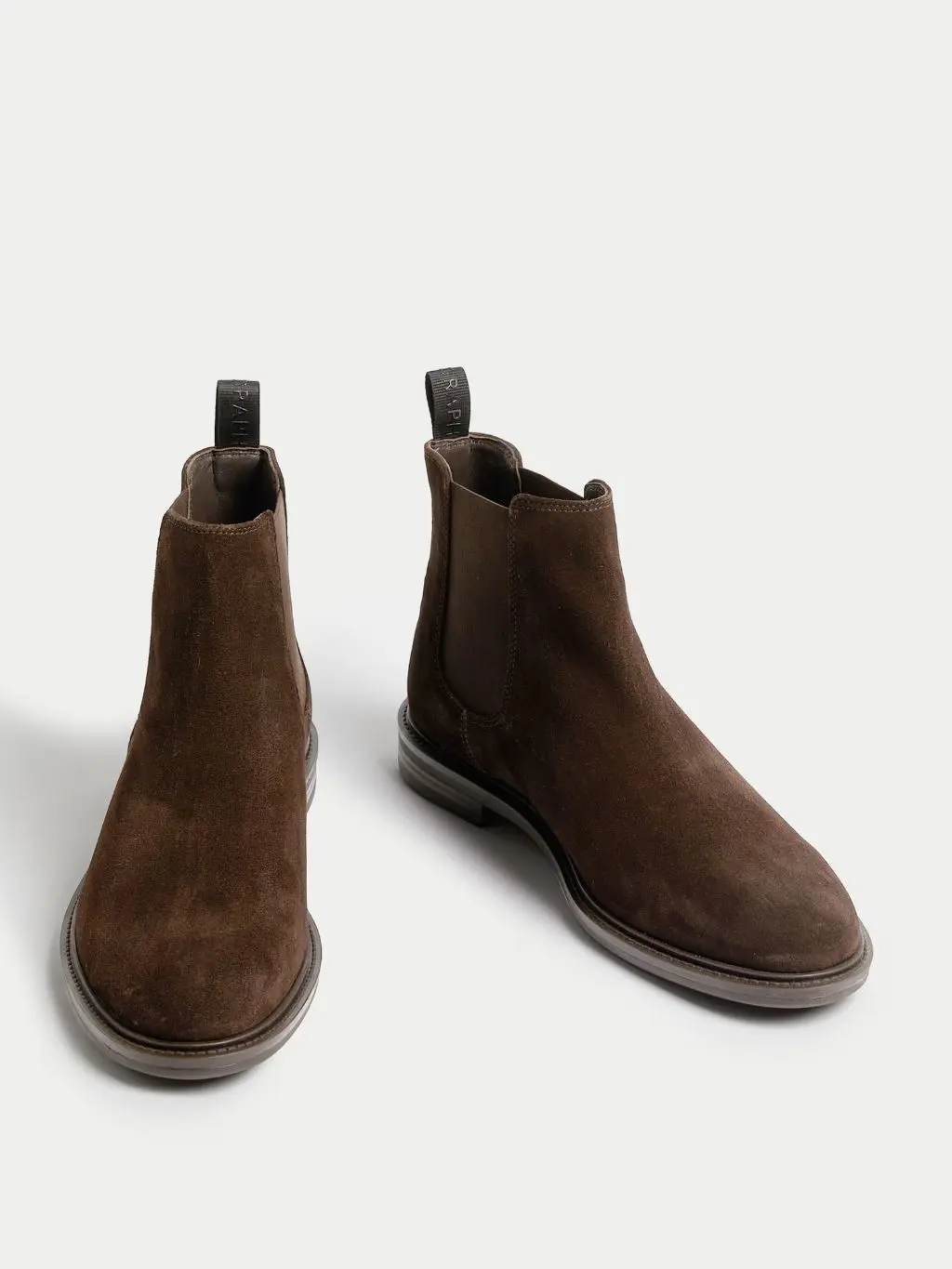 A cutout of brown suede Chelsea boots