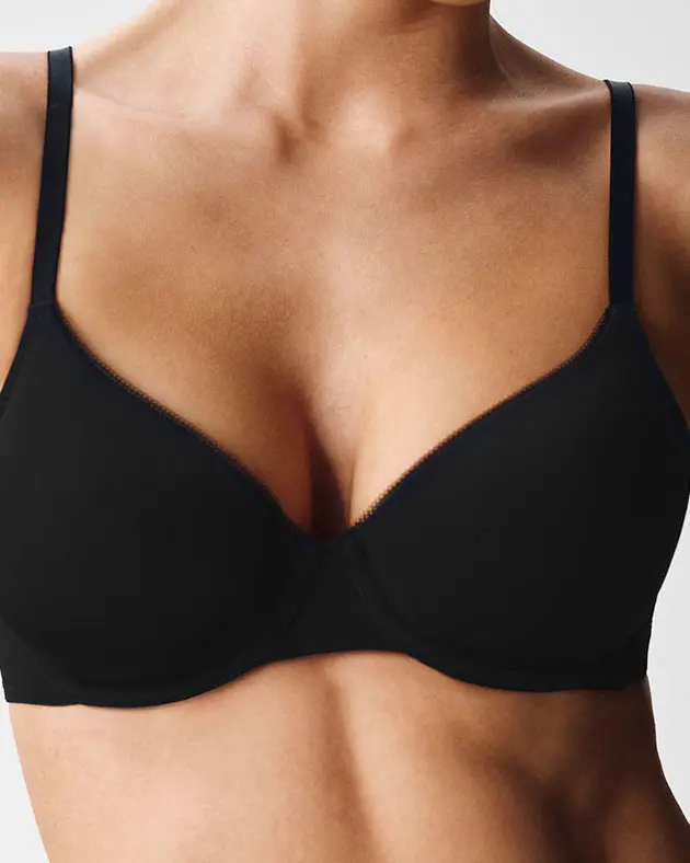 Woman wearing black full-cup bra