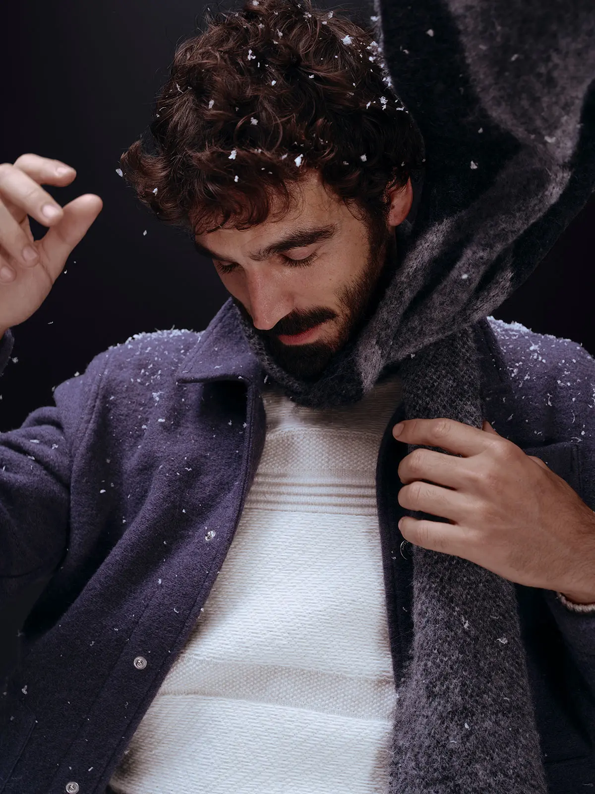 Man wearing knitwear, navy jacket and scarf