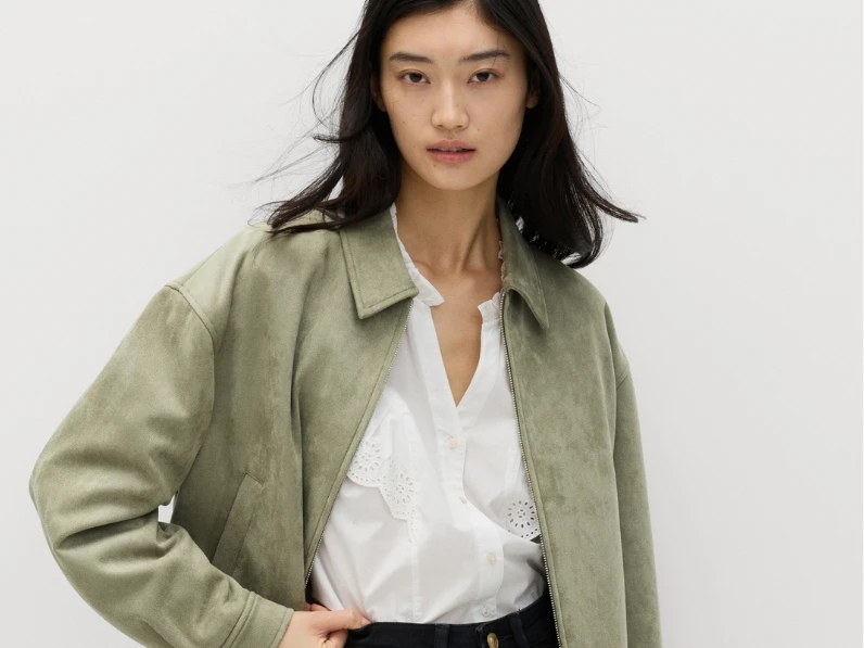 Woman wearing suede bomber jacket
