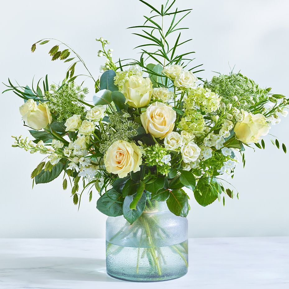Image of a white rose bouquet in a glass vase. Shop next-day delivery flowers