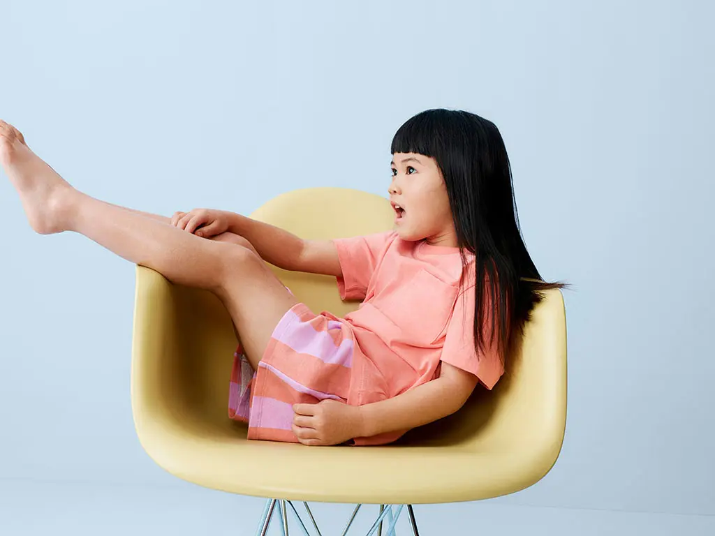 Girl wearing orange T-shirt and pink and orange shorts