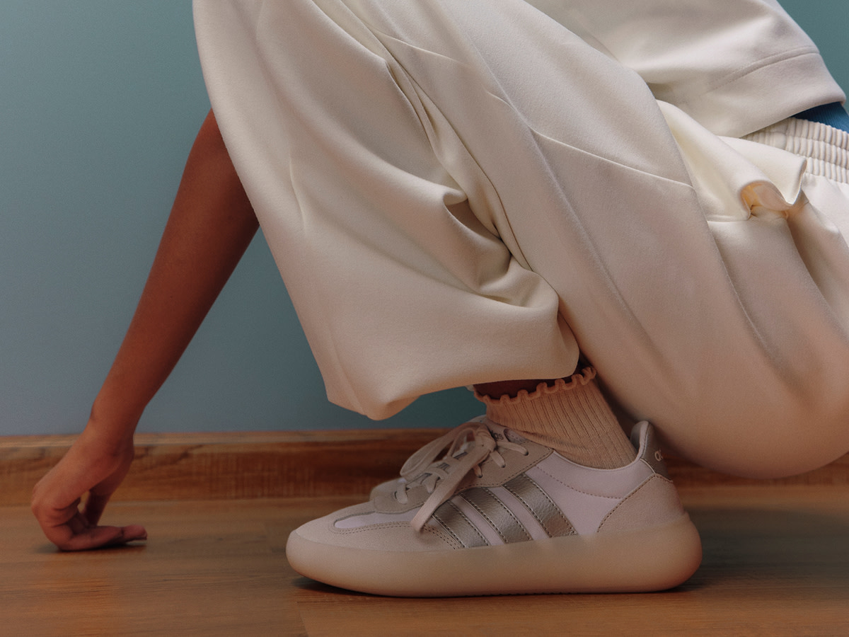 Woman wearing cream joggers and trainers by adidas