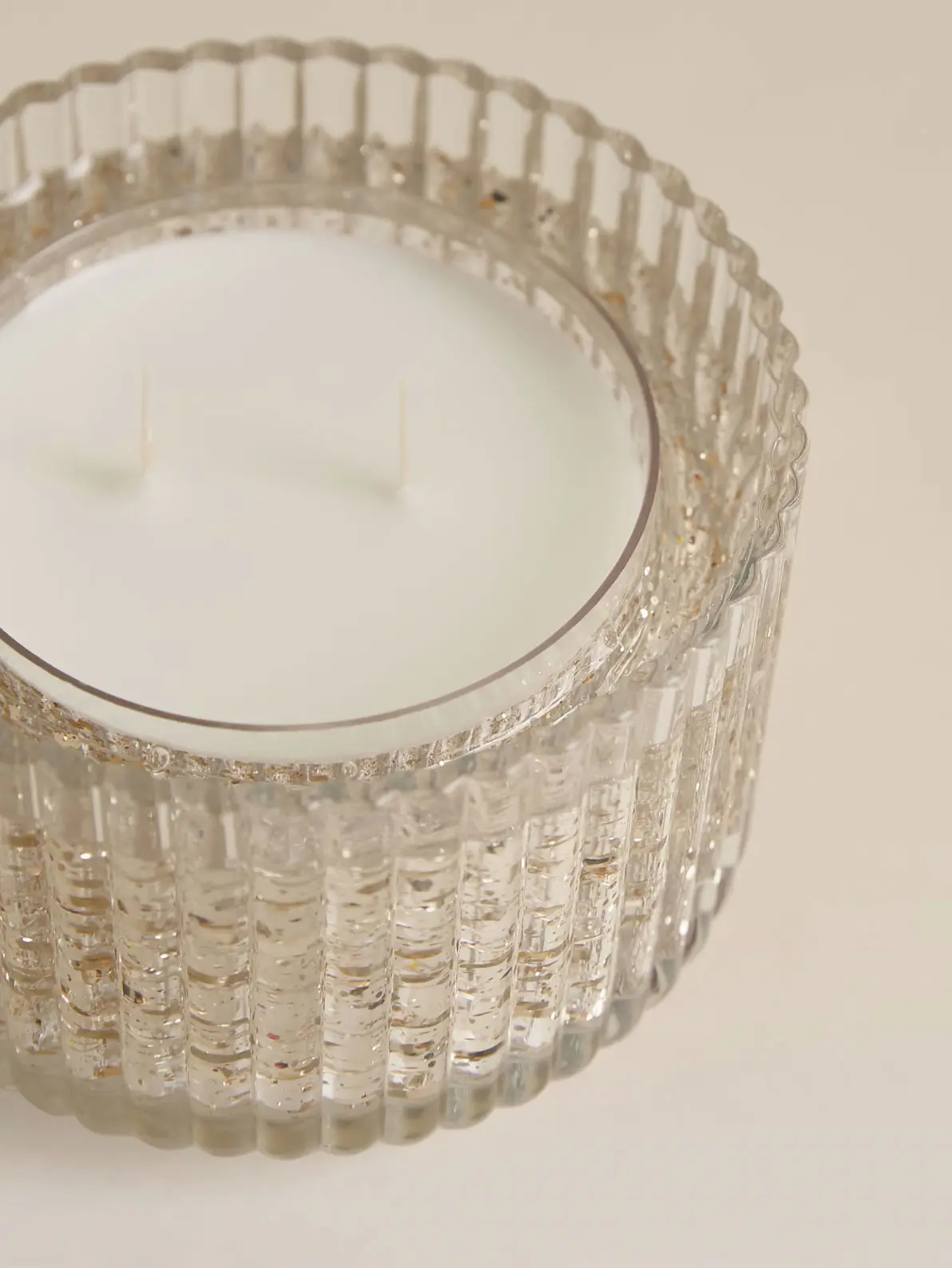 White two wick candle in textured glass jar