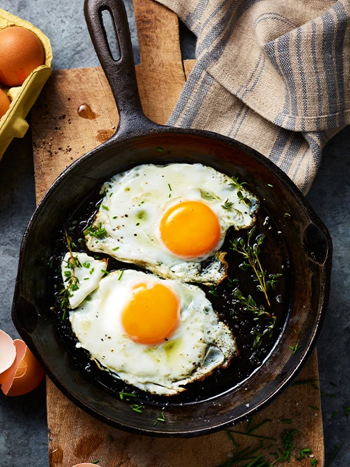 frying eggs in a pan