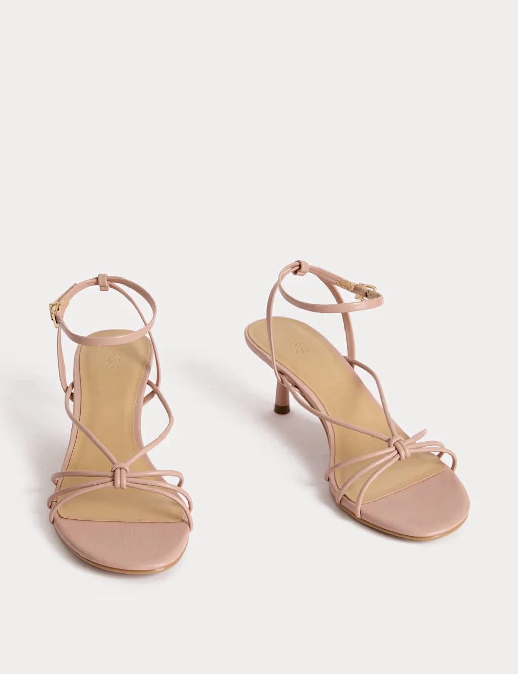 A pair of strappy light pink sandals