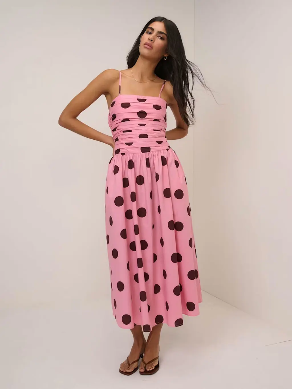 Woman wearing a pink polka-dot dress