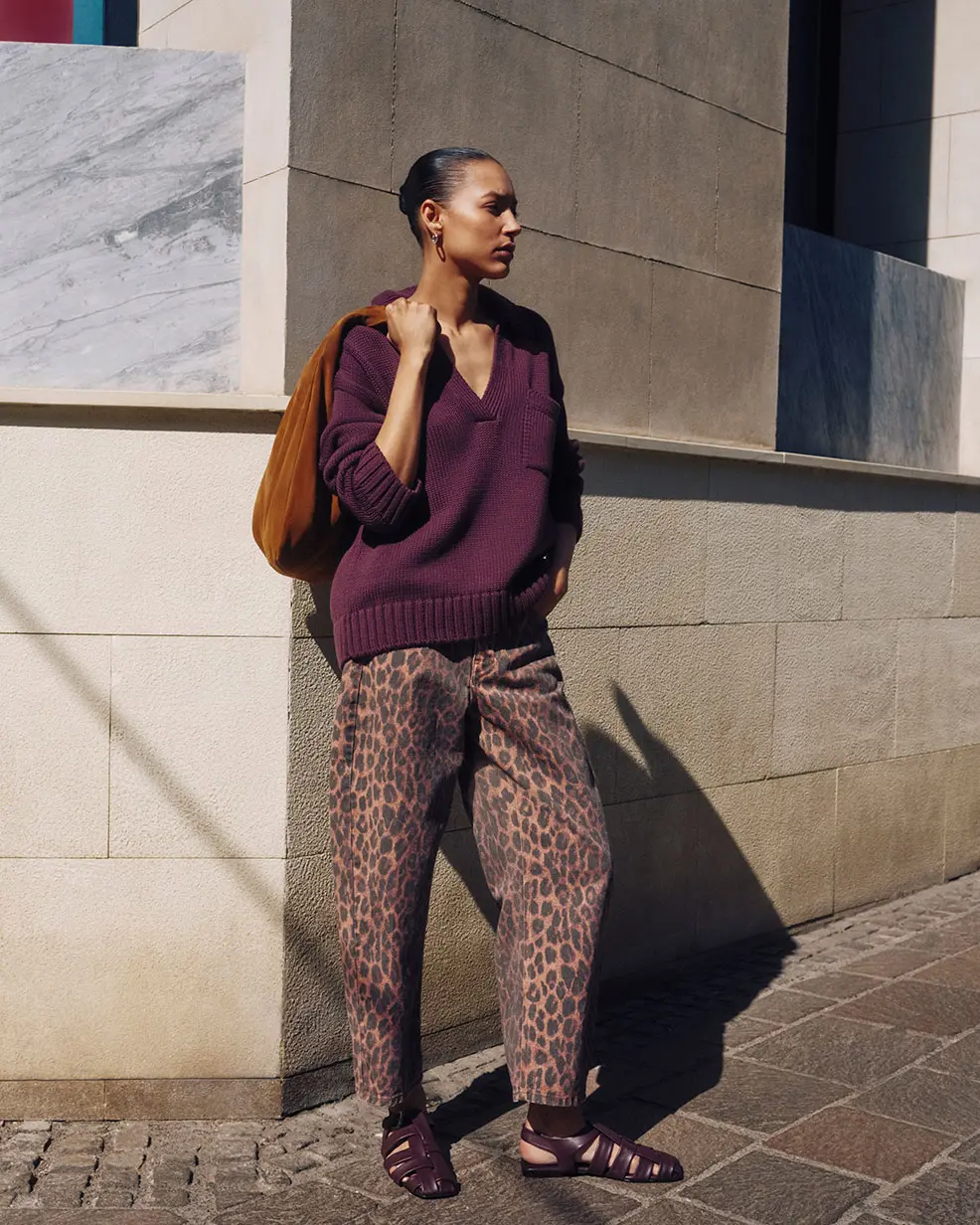 Woman wearing burgundy jumper and leopard-print jeans from Hush at M&S