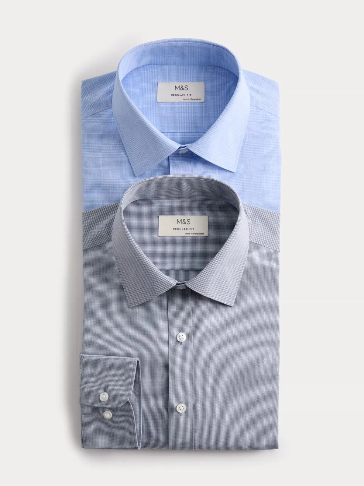 Two folded shirts in blue and grey 