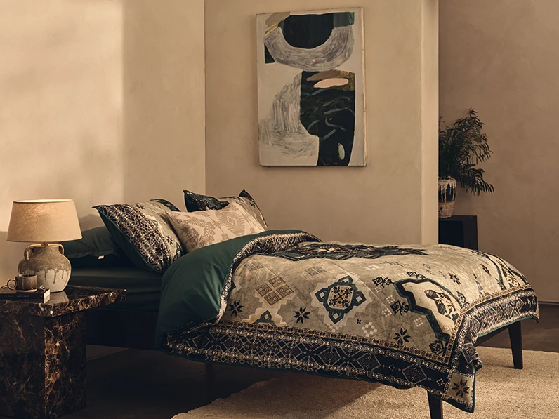 Bedroom with bed made up with M&S X Fired Earth bedding