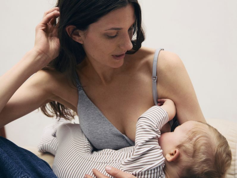 Woman breastfeeding in an M&S maternity bra