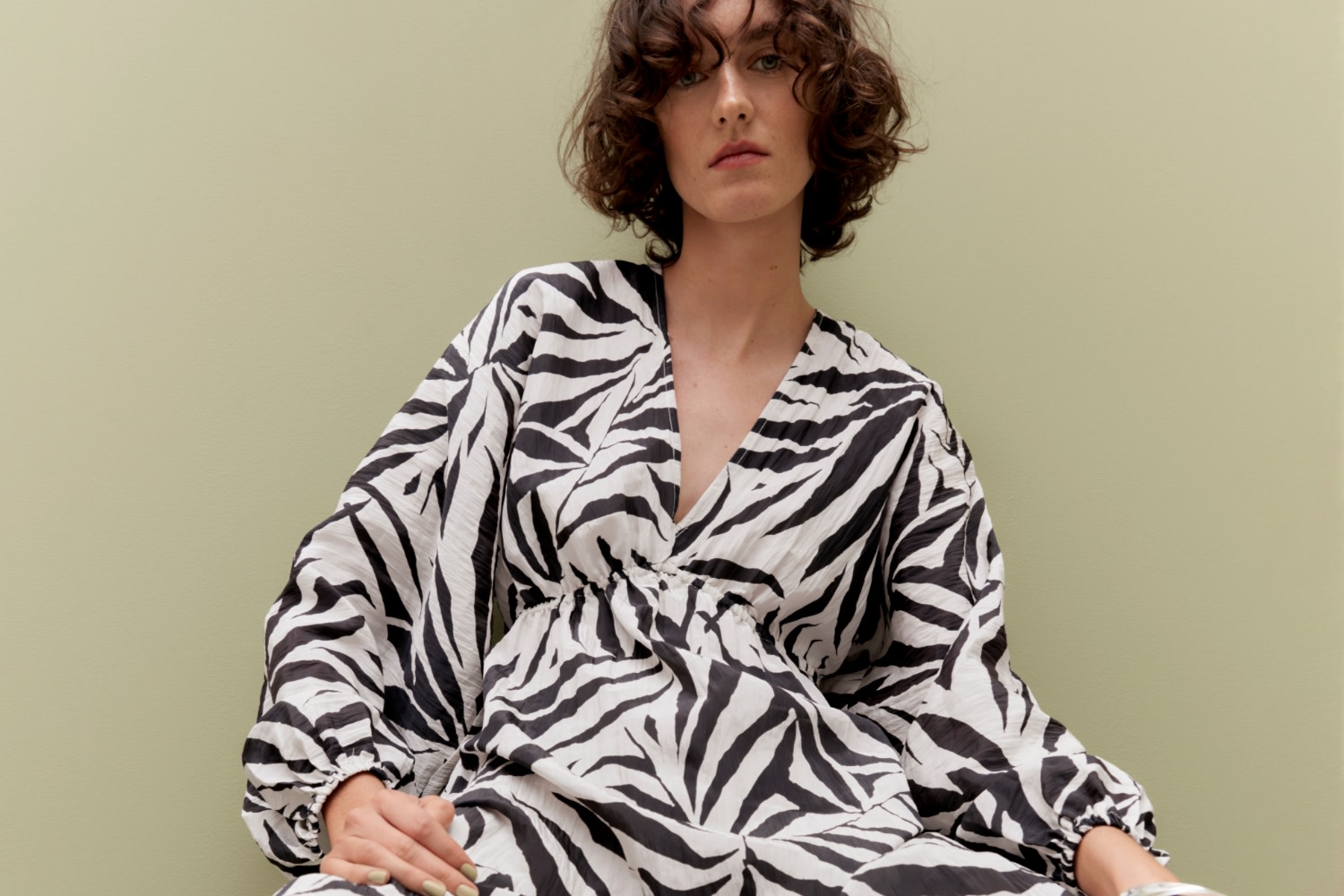 Woman wearing black and white printed dress. Shop The Edit