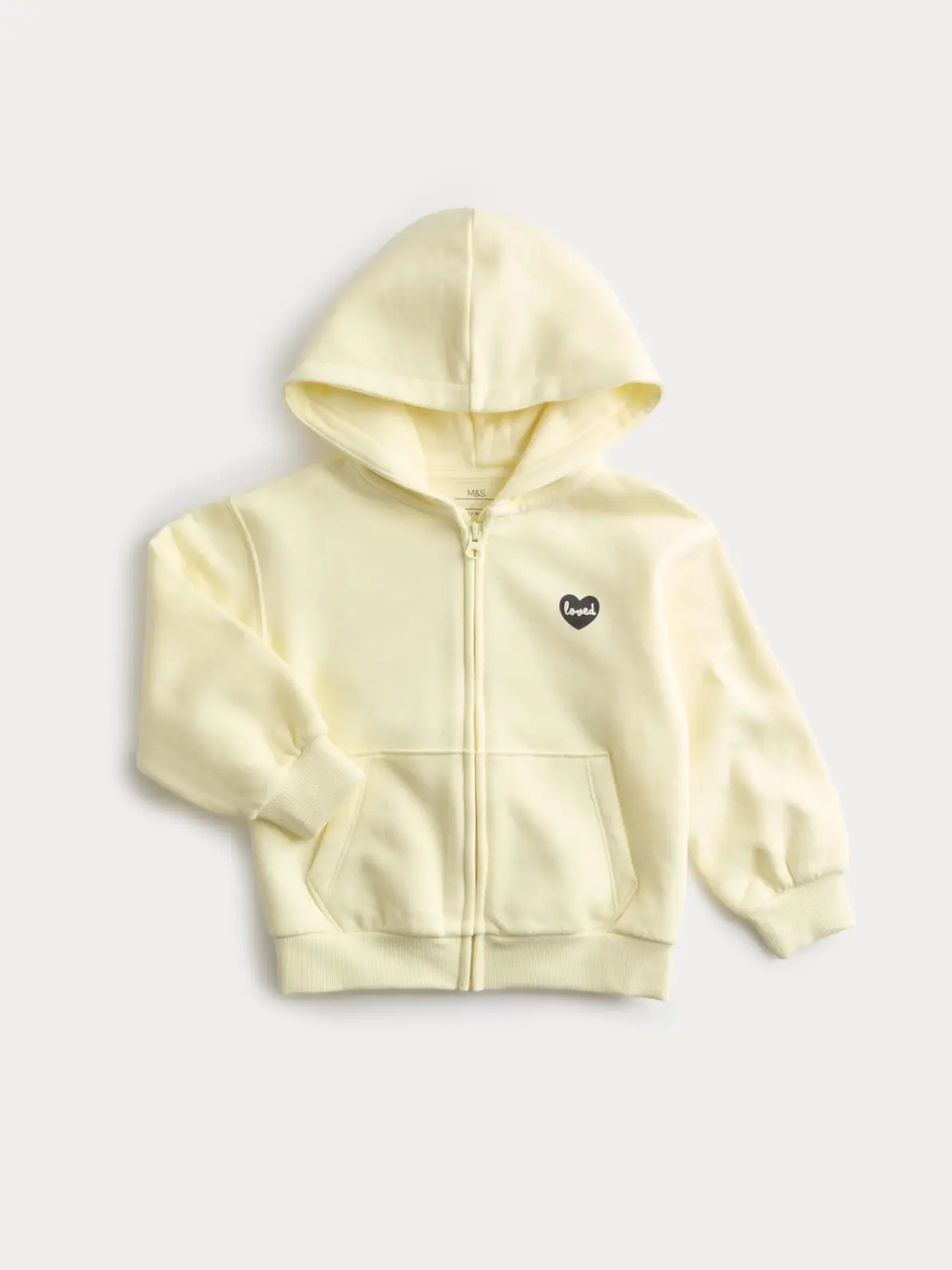 Butter yellow hoodie with side pockets and a small black heart logo