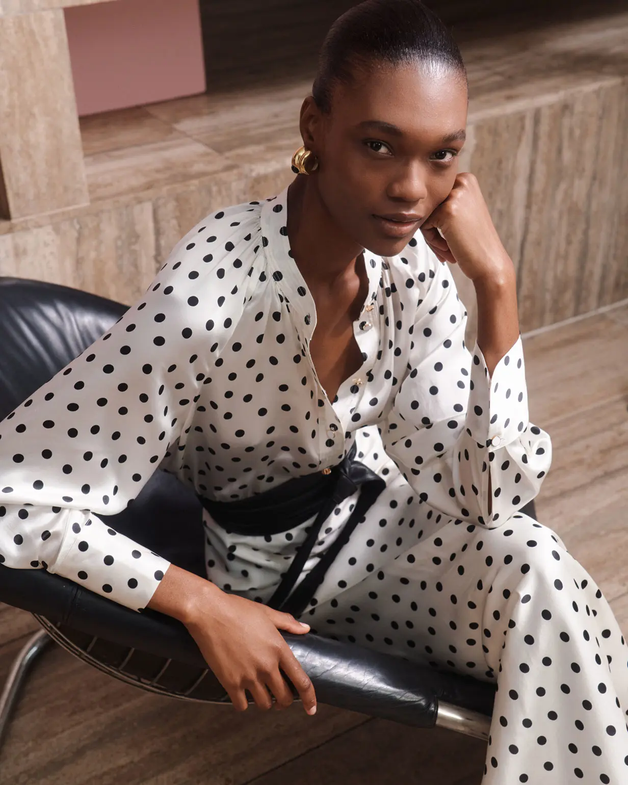Woman wearing white and black polka-dot dress by Saba