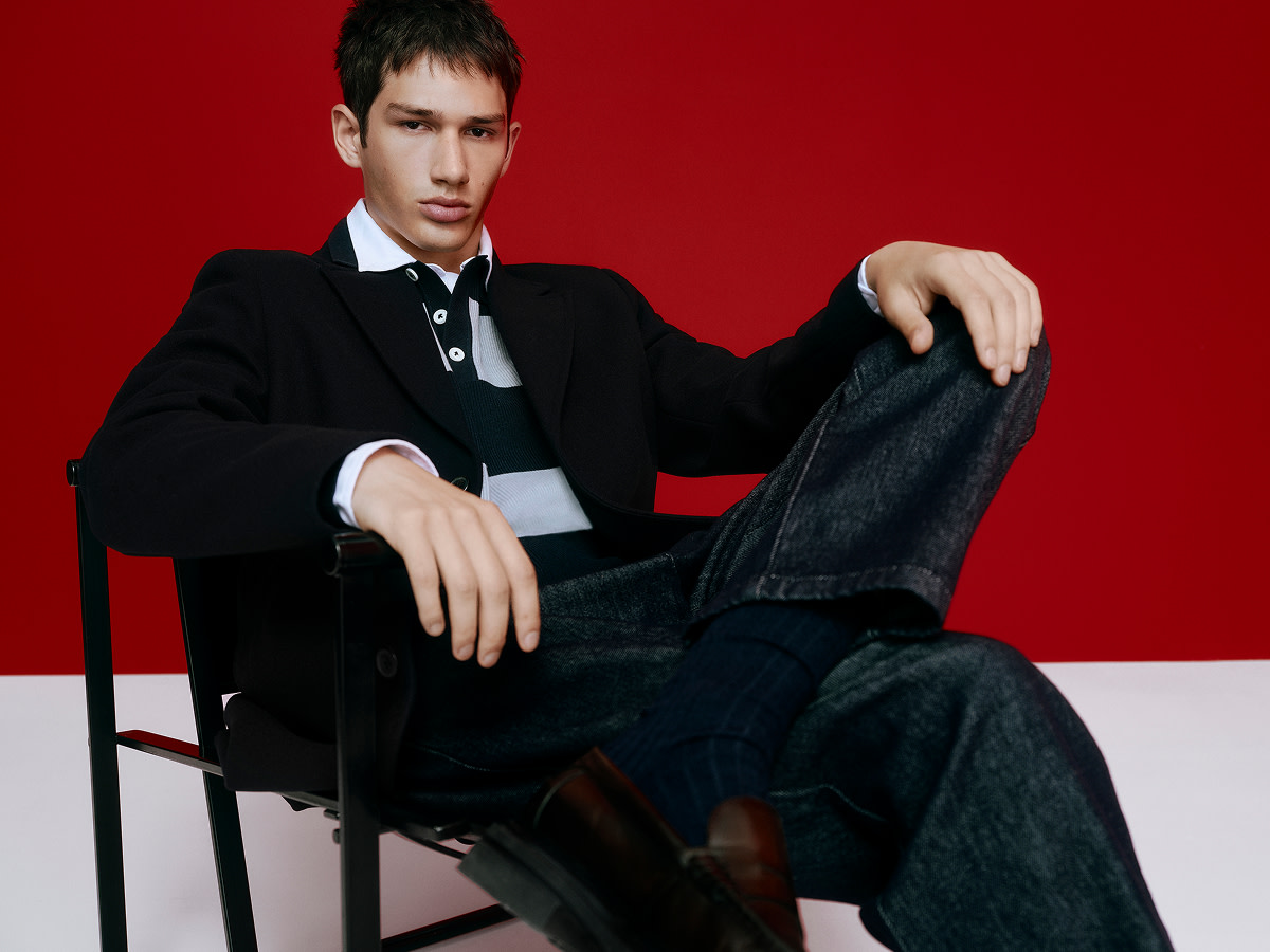 Man wearing black jacket with polo shirt