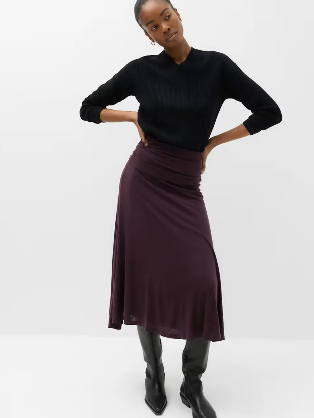 Woman in burgundy skirt and black top