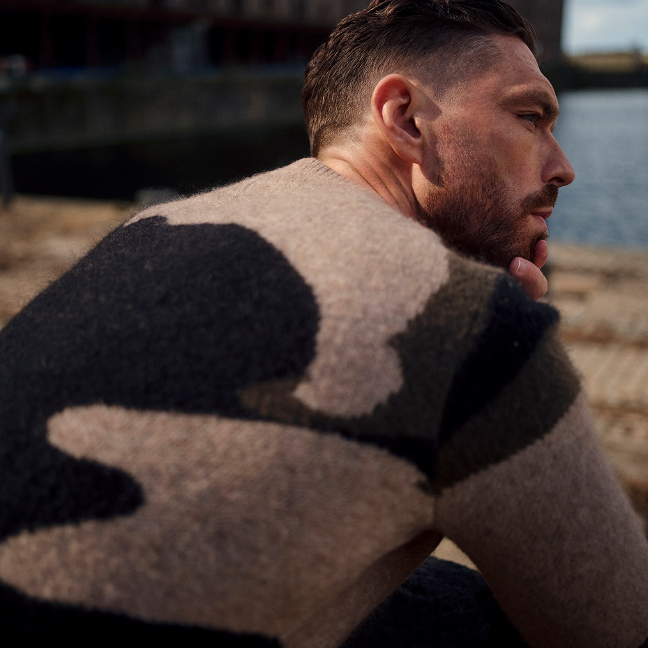 Man wearing brown patterned jumper