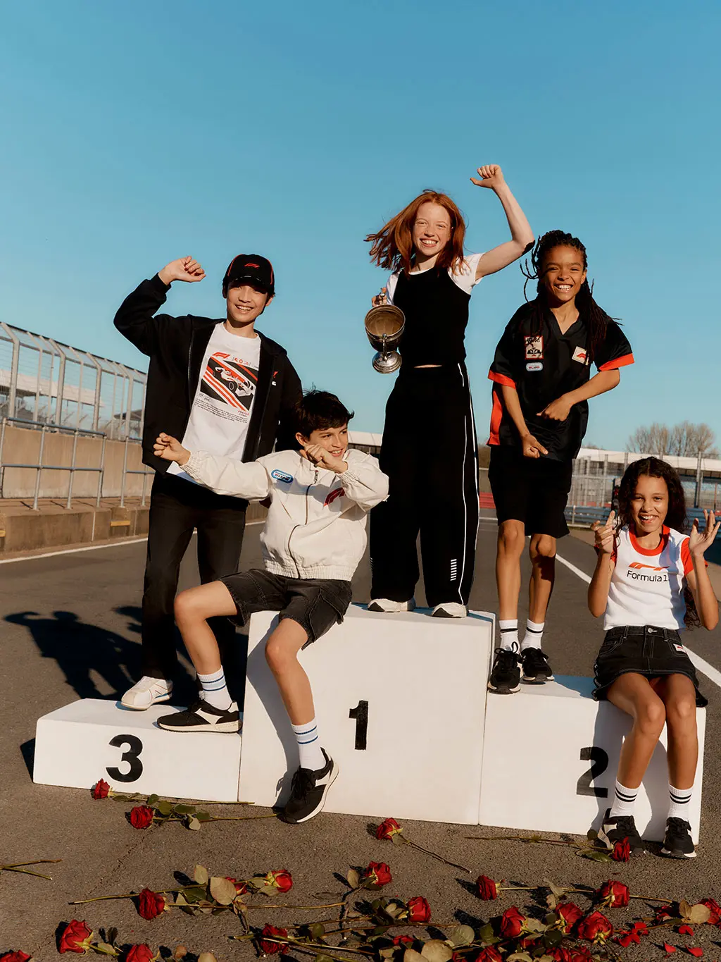 Kids on winners platform on race track