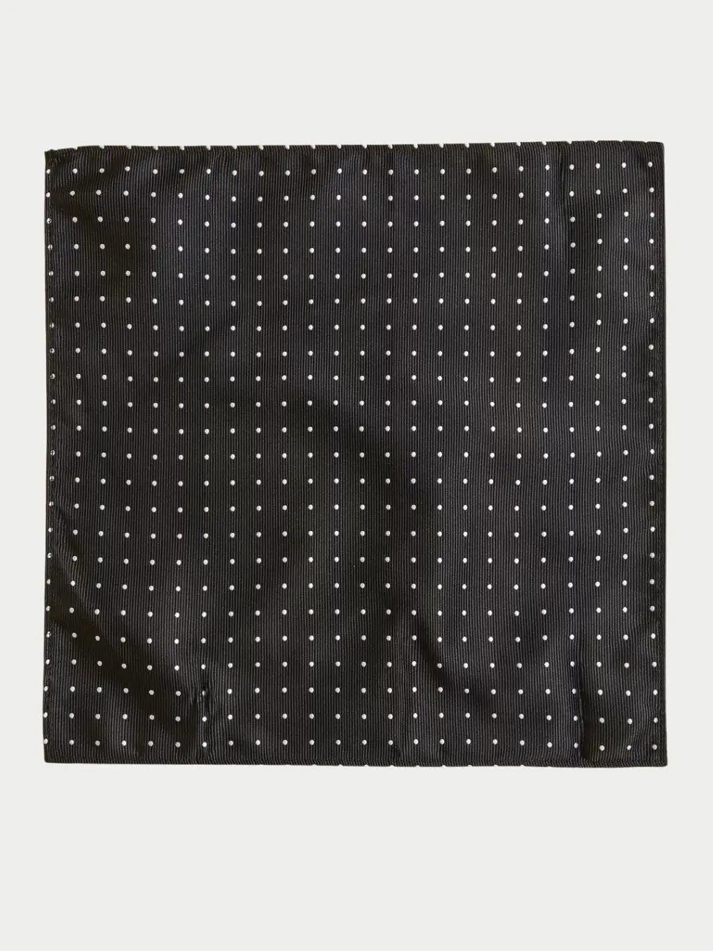 A black and white polka-dot pocket square 
