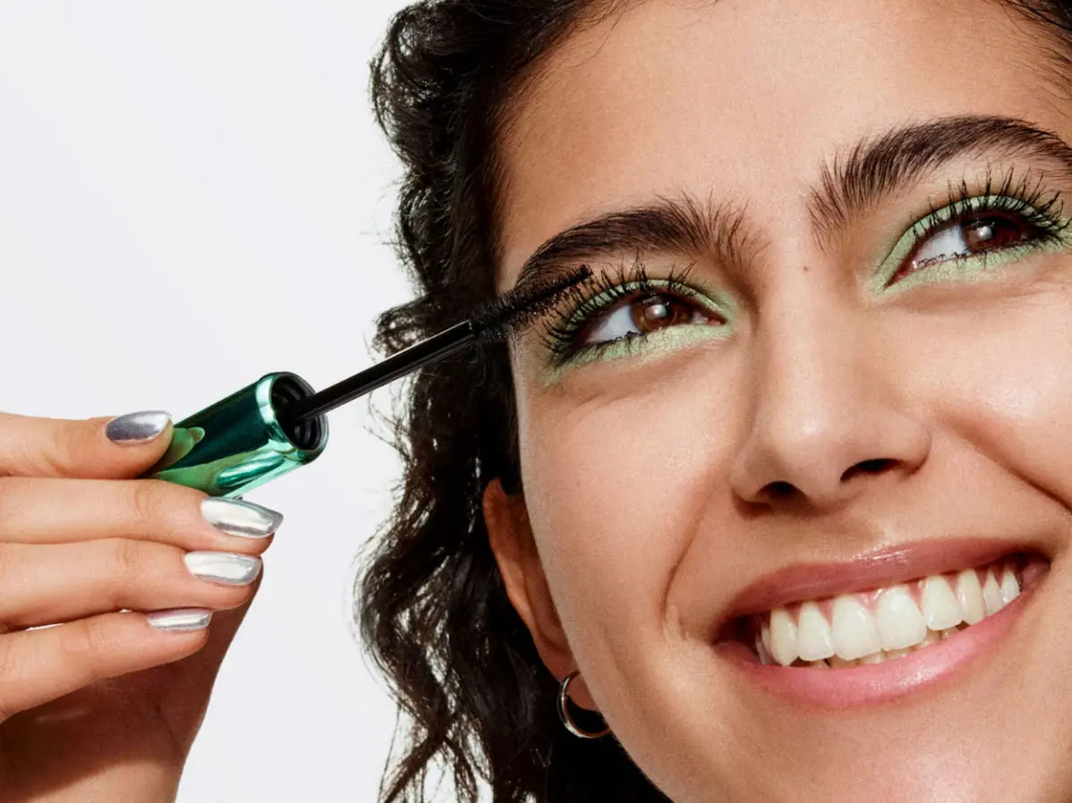 Woman applying mascara 