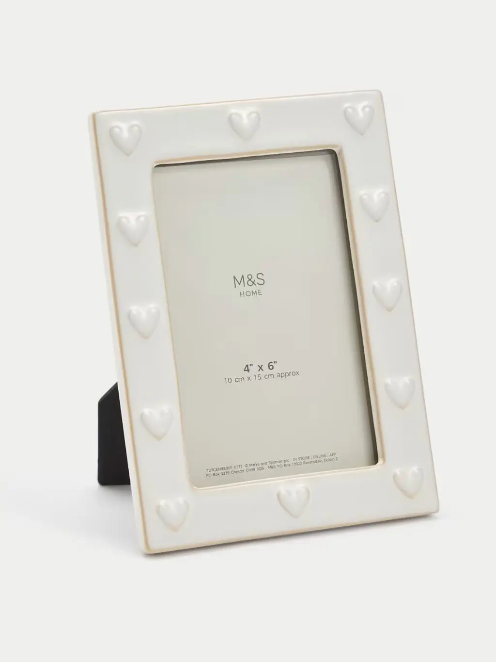 A white photo frame with hearts sat against a light background