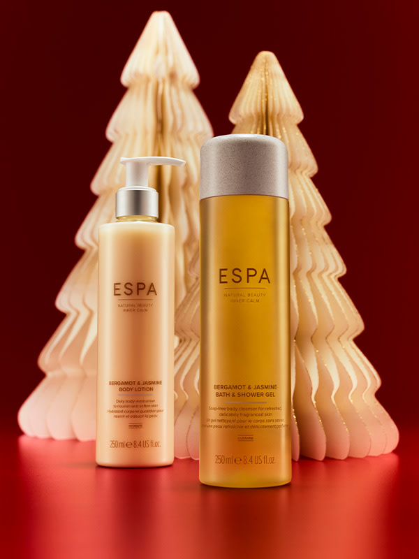 Skincare products against white tree