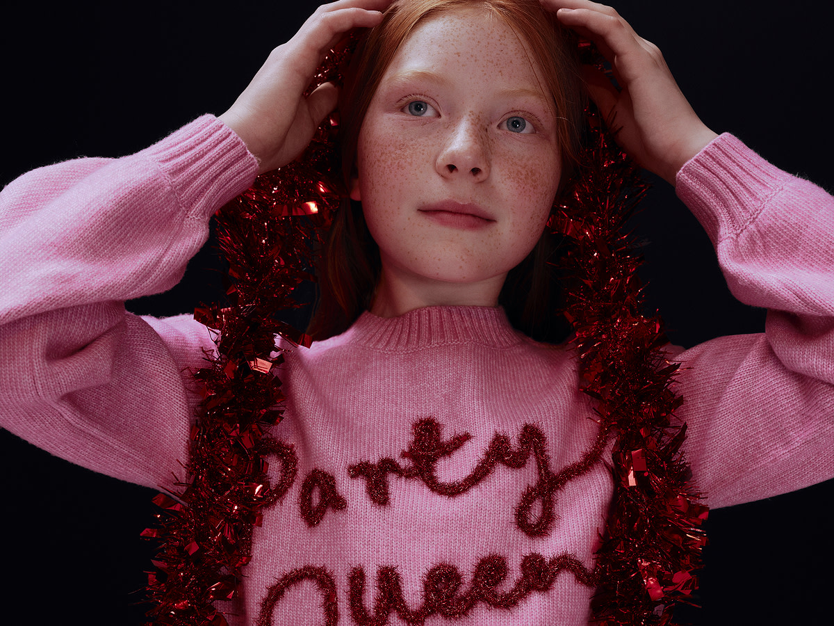 Girl wearing a Christmas jumper at M&S
